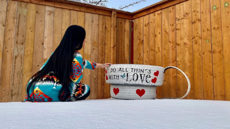 Pearl Gambler touches one of many memorials at her home to her daughter Sakihitowin, whose name means “love.”